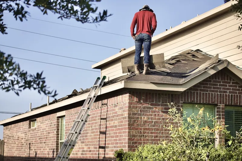 Professional roofer working on a residential roof in Far East